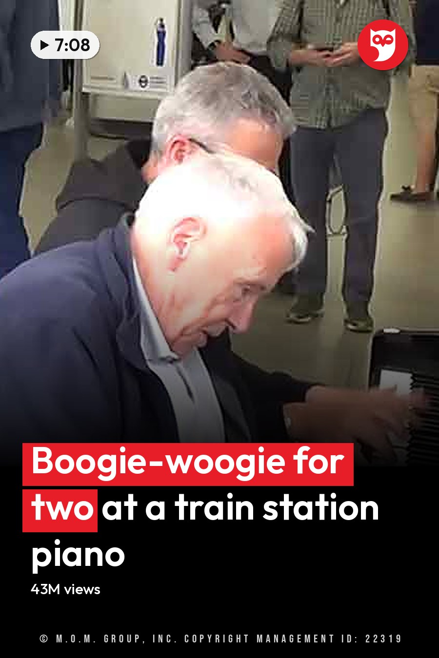 A man playing a piano on a train station platform with other people waiting in the background. The headline runs in white letters across the lower third.