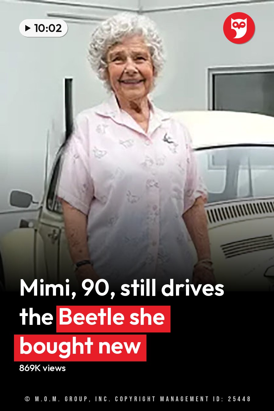 An older adult female wearing a light pink button-up shirt with small floral patterns stands next to a vintage Volkswagen Beetle at a service center, holding hands with an adult male in a light gray hoodie and black cap. The headline runs in white letters across the lower third.