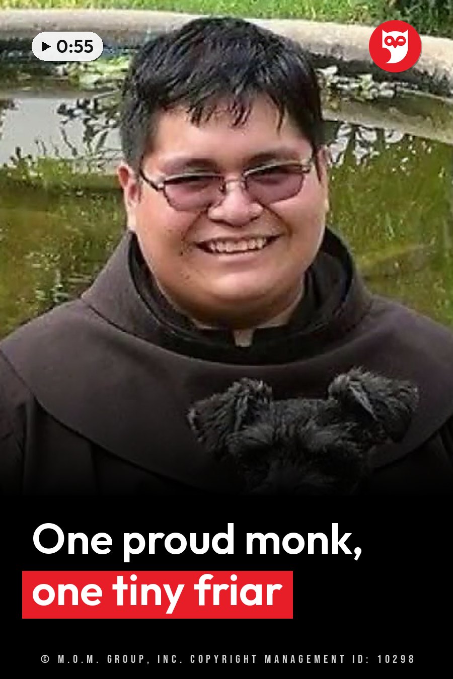 A smiling person in glasses and a brown robe holds a small dog near water and green plants. A headline runs in white letters across the lower third.