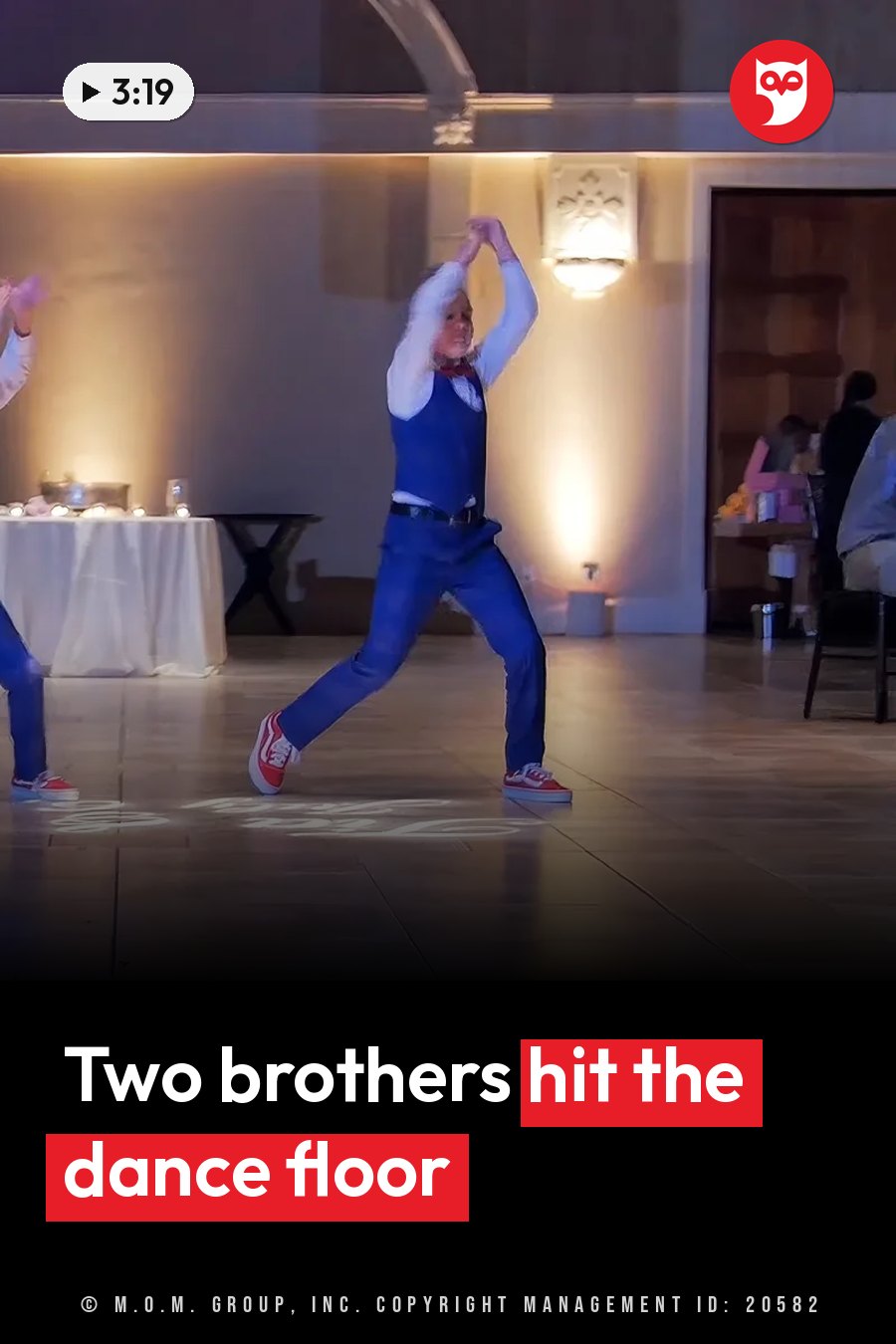 A dancer in a blue suit and red sneakers raises both arms on a wooden floor. A headline runs in white letters across the lower third.