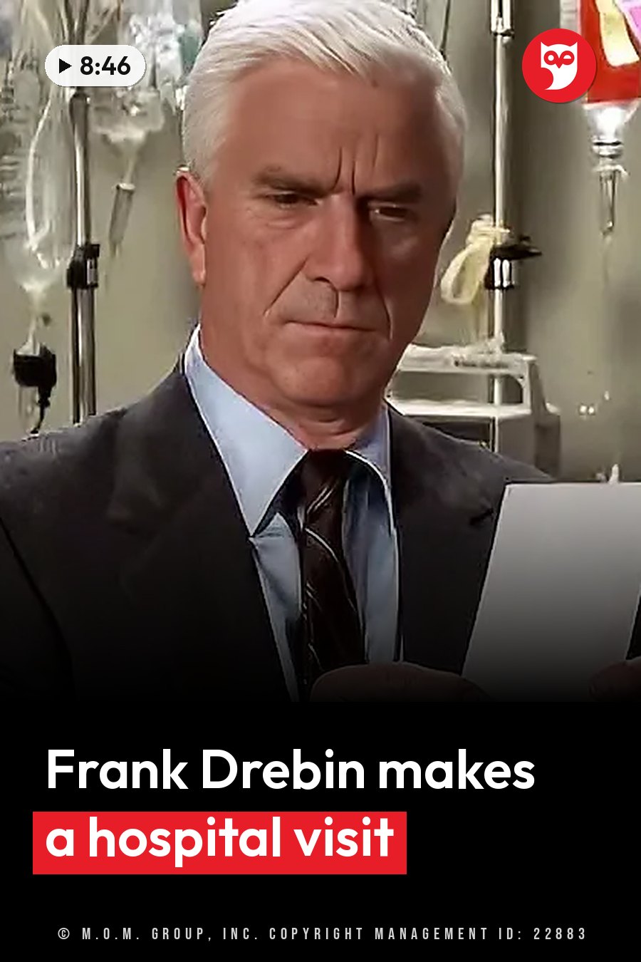A man with white hair, in a suit and tie, holds papers and looks down in a medical setting. A headline runs in white letters across the lower third.