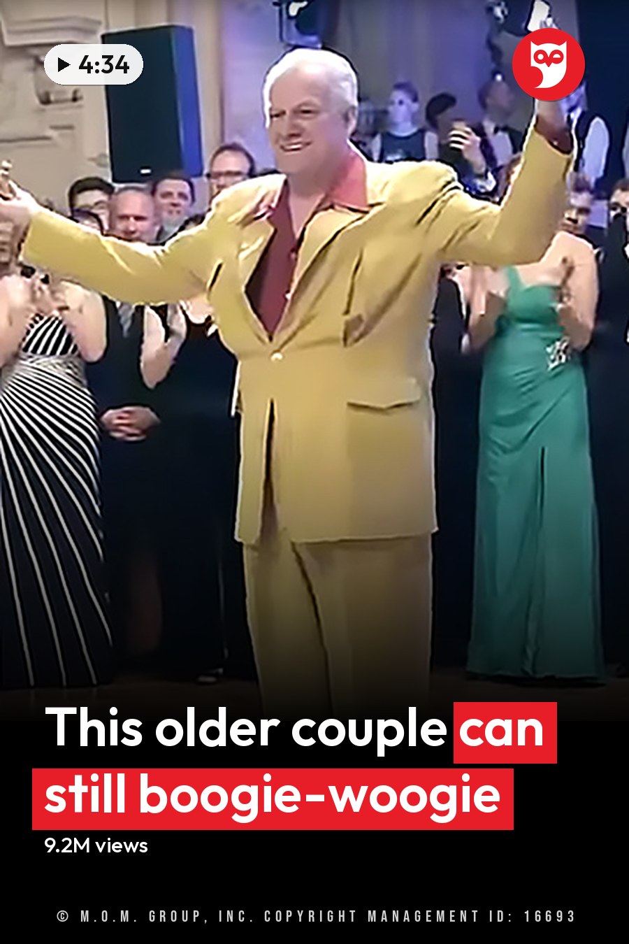An adult male singer in a bright yellow suit dancing with an older adult woman in a floral dress at an elegant indoor event. The headline runs in white letters across the lower third.