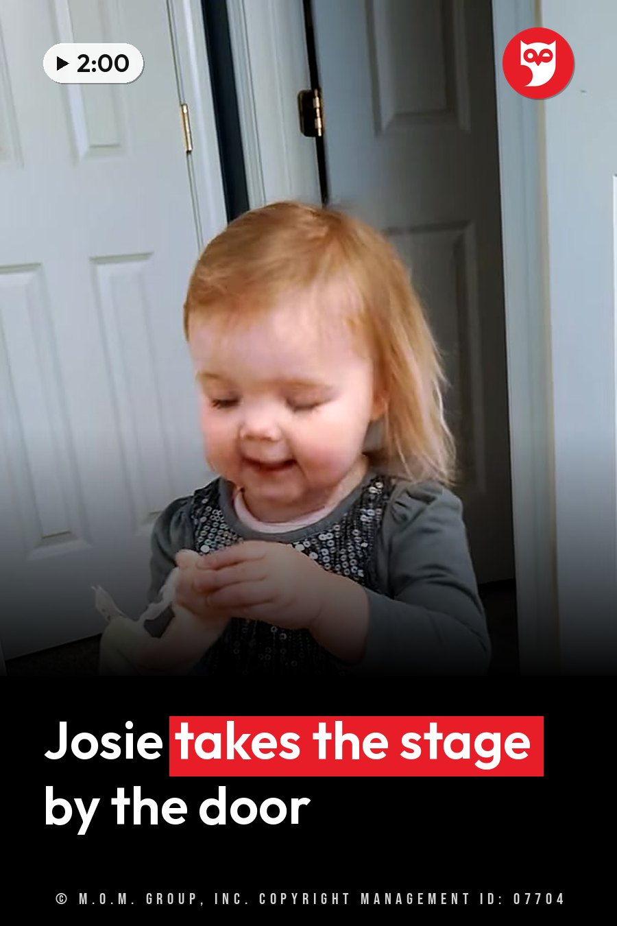 A smiling toddler with light hair holds a small object while standing near a white door. A headline runs in white letters across the lower third.