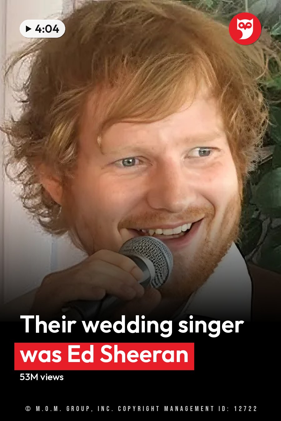 A young adult male with reddish-brown hair and beard sings into a microphone at an indoor event while wearing a white dress shirt, purple tie, and brown suspenders. The headline runs in white letters across the lower third.