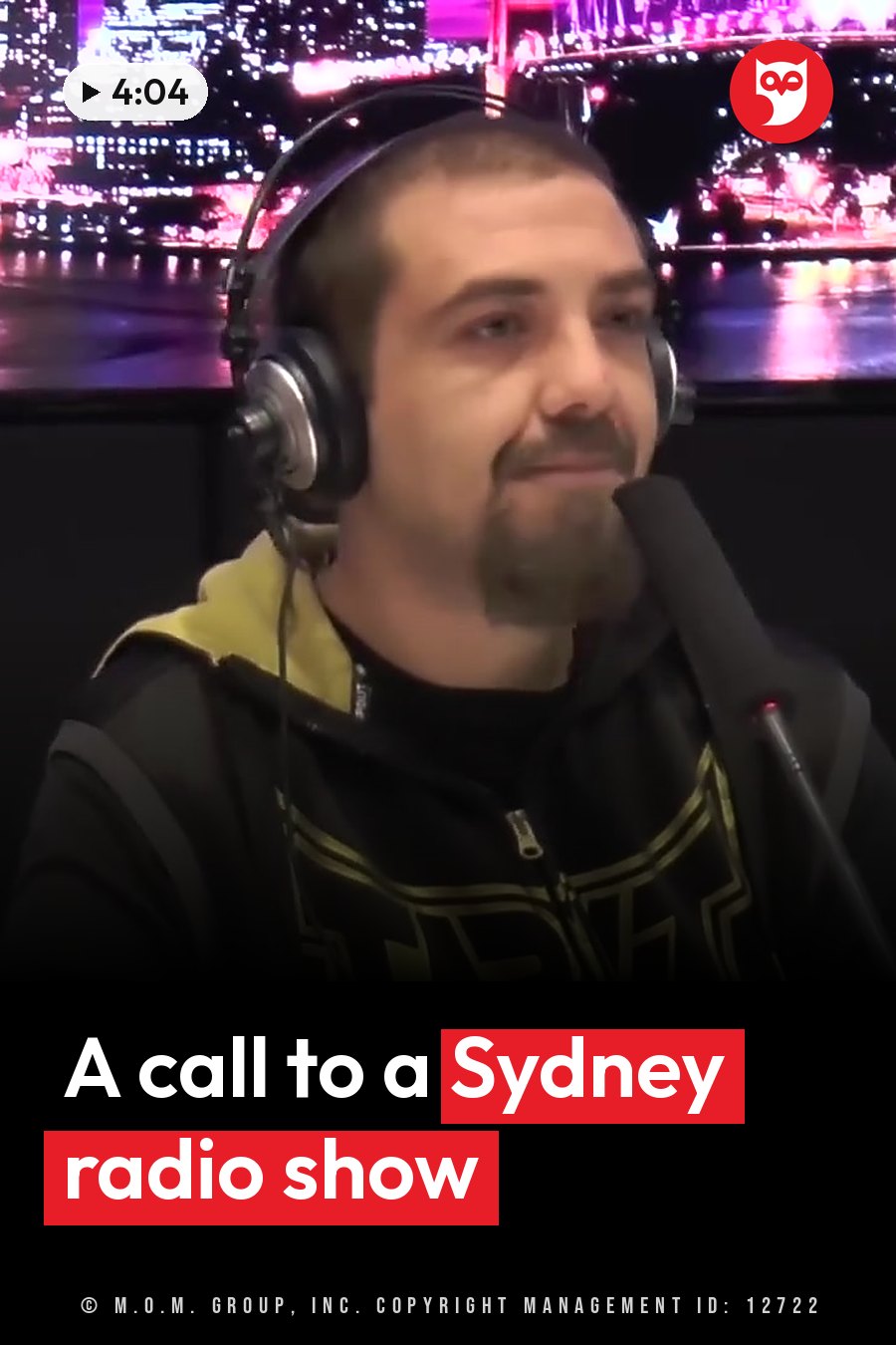 A man wearing headphones speaks into a microphone in front of a city skyline backdrop. A headline runs in white letters across the lower third.