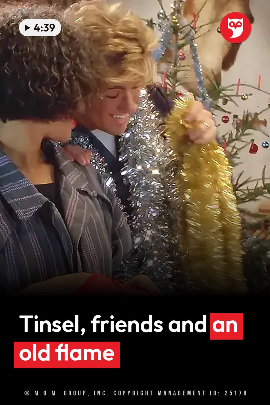 Two smiling people decorate a Christmas tree, and one of them holds a strand of gold tinsel. A headline runs in white letters across the lower third.