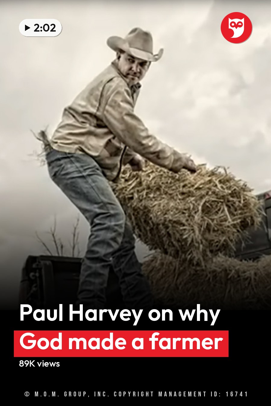 A middle-aged man in a light-colored shirt and blue jeans loads hay into a black pickup truck on an overcast day in an open field with dry grass, wire fence, and trees. The headline runs in white letters across the lower third.