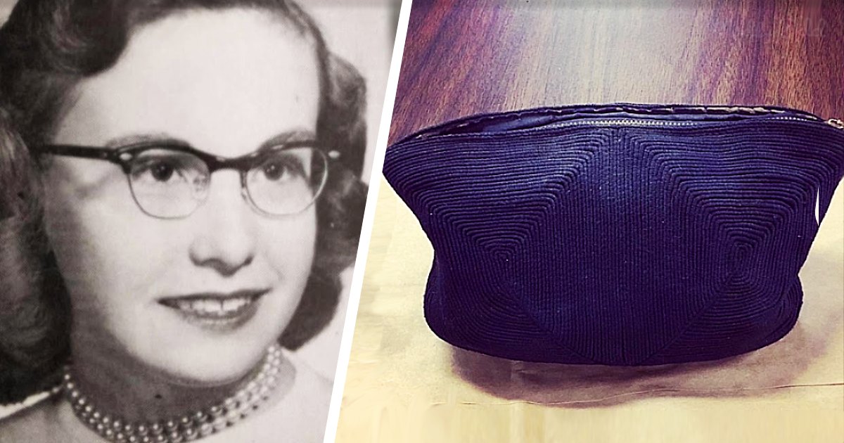 Middle-aged adult female wearing pearl necklace, glasses with thick frames, light-colored garment; purple handbag with geometric pattern in foreground indoors.
